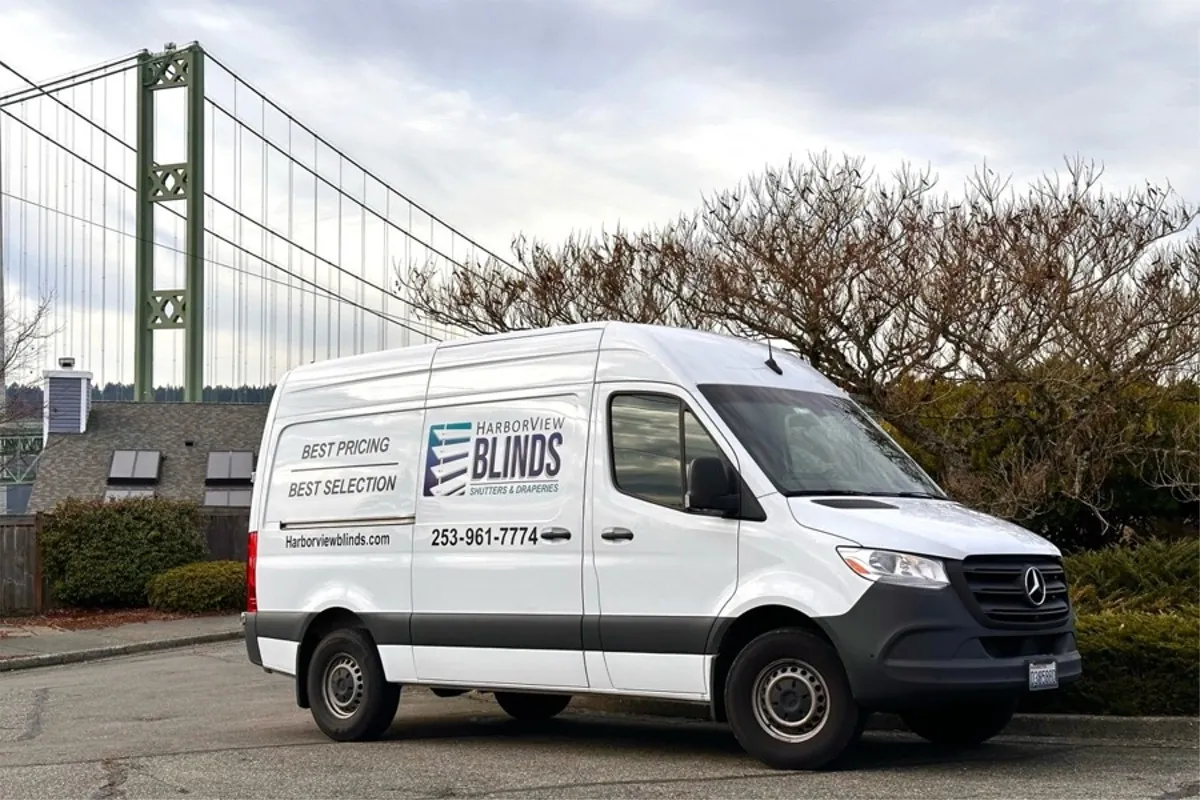 The Harbor View Blinds van parked below the Tacoma Narrows Bridge