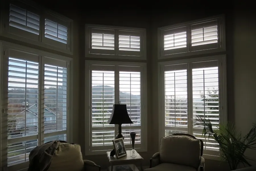Wood plantation shutters across a bay window, Lynda F project